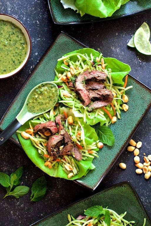 Thai Beef Lettuce Wraps with Mint Dressing and Vegetable Slaw on square green plate.