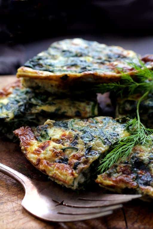 Photo of pieces of frittata piled up on wood trivet.
