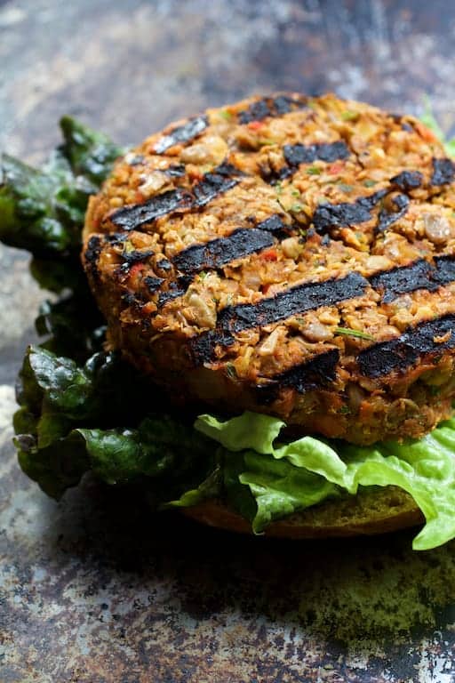 Photo of burger on bun after being grilled.