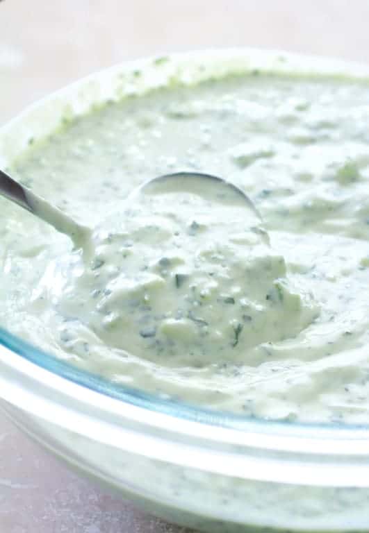 Photo of tzatziki sauce in glass bowl.