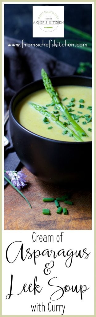 Pinterest graphic for Cream of Asparagus Soup with Curry showing it in a black bowl on wood cutting board garnished with fresh chives.