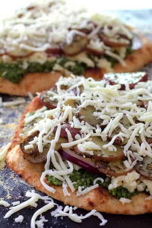 Photo of Naan Potato Pizza with Radish Pesto and Smoked Mozzarella before being cooked.
