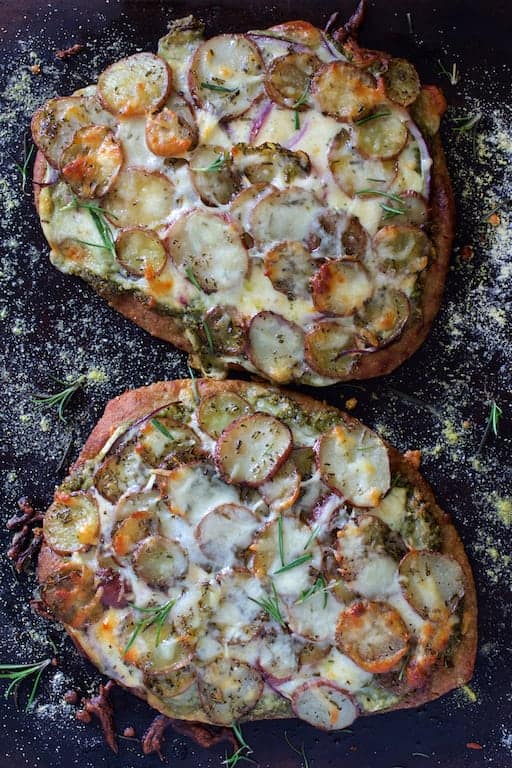 Photo of whole Baked Naan Potato Pizza with Radish Pesto and Smoked Mozzarella before being cut.