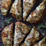 Naan Potato Pizza with Radish Pesto and Smoked Mozzarella cut into eight slices.