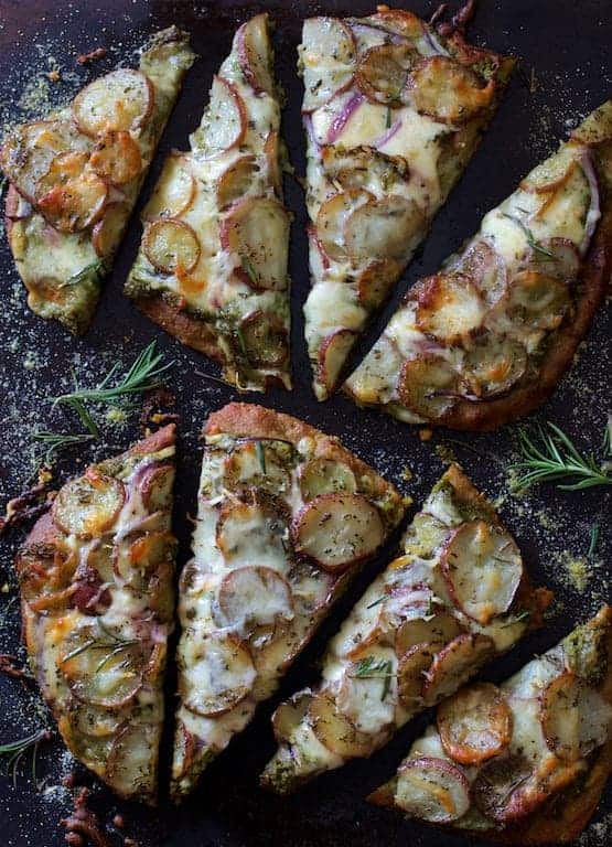 Naan Potato Pizza with Radish Pesto and Smoked Mozzarella cut into eight slices.