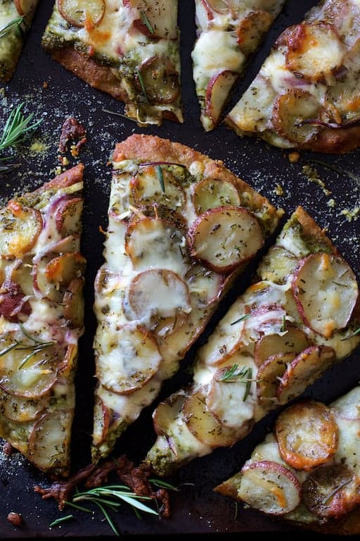 Close-up of Naan Potato Pizza with Radish Pesto and Smoked Mozzarella cut into slices.