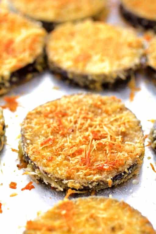 Photo of crispy golden eggplant slices on baking sheet after being baked.