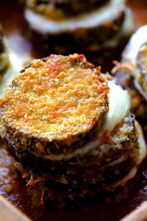 Close-up photo of one of an eggplant stack with melty cheese between the layers.