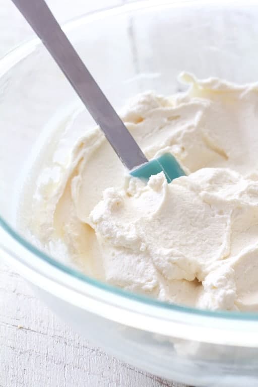 Photo of mascarpone cream in glass mixing bowl.