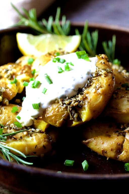Close-up photo of Rosemary Garlic Crushed Potatoes with Lemon Chive Aioli.