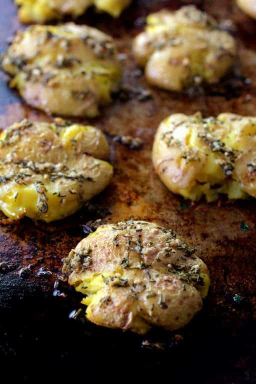Photo of Rosemary Garlic Crushed Potatoes on baking sheet.