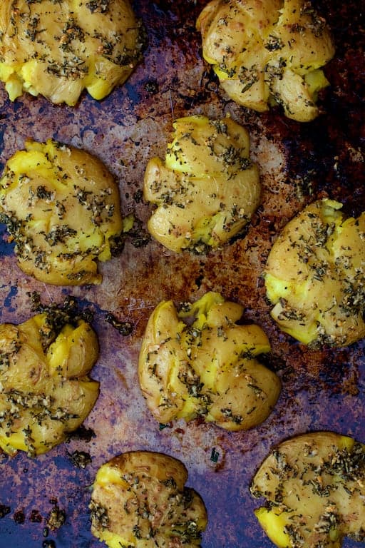 Photo of Rosemary Garlic Crushed Potatoes on baking sheet.