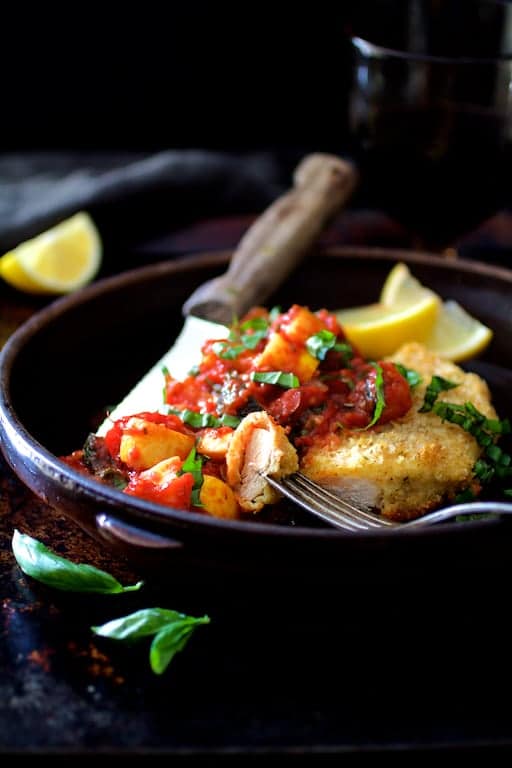 Photo of Chicken Scallopini with Roasted Vegetable Ratatouille in clay dish with a piece on a fork.