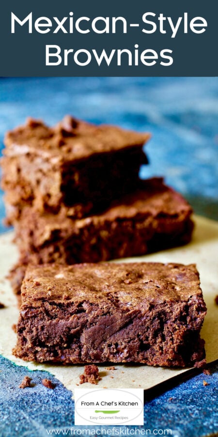 Pinterest graphic for Mexican-Style Brownies showing cut squares stacked on parchment paper.