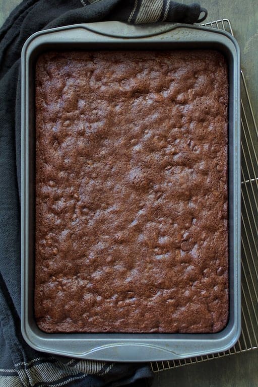 Photo of whole pan of baked Whole Wheat Ancho Chili Brownies on cooling rack.