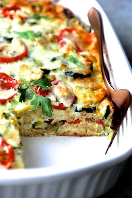 Photo of Four Cheese Strata with Zucchini and Tomatoes with piece removed showing the layers.