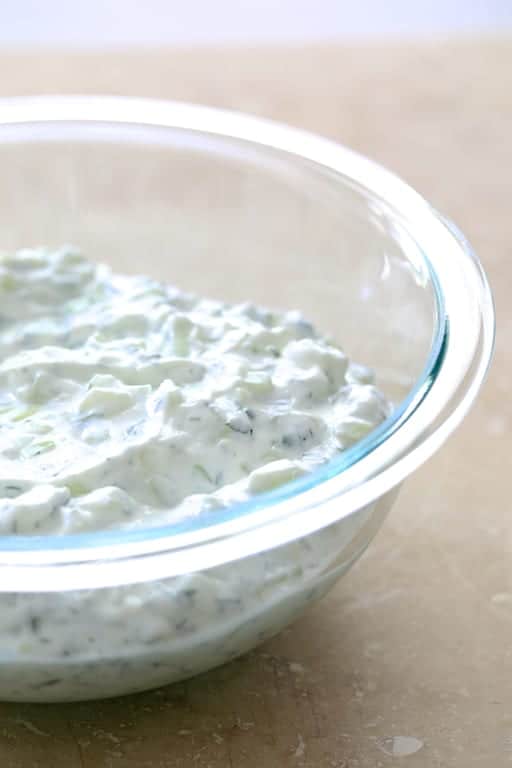 Photo of tzatziki sauce in glass bowl.