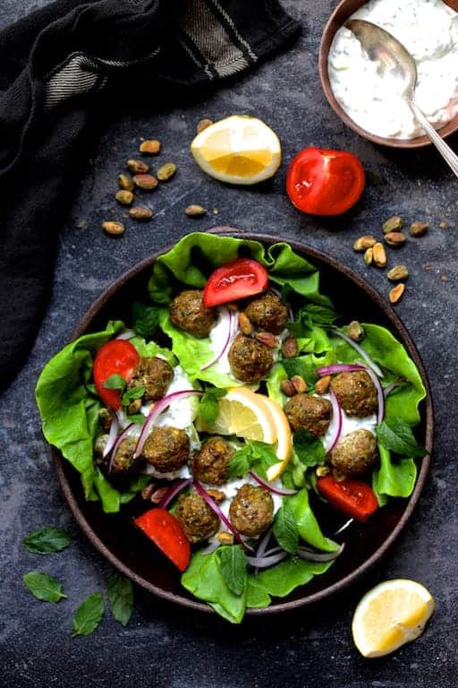 Turkish Turkey Meatball Wraps and all the accompaniments in brown ceramic bowl.