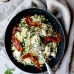 Creamy One Pot Chicken and Orzo Risotto with Bacon in black bowl.