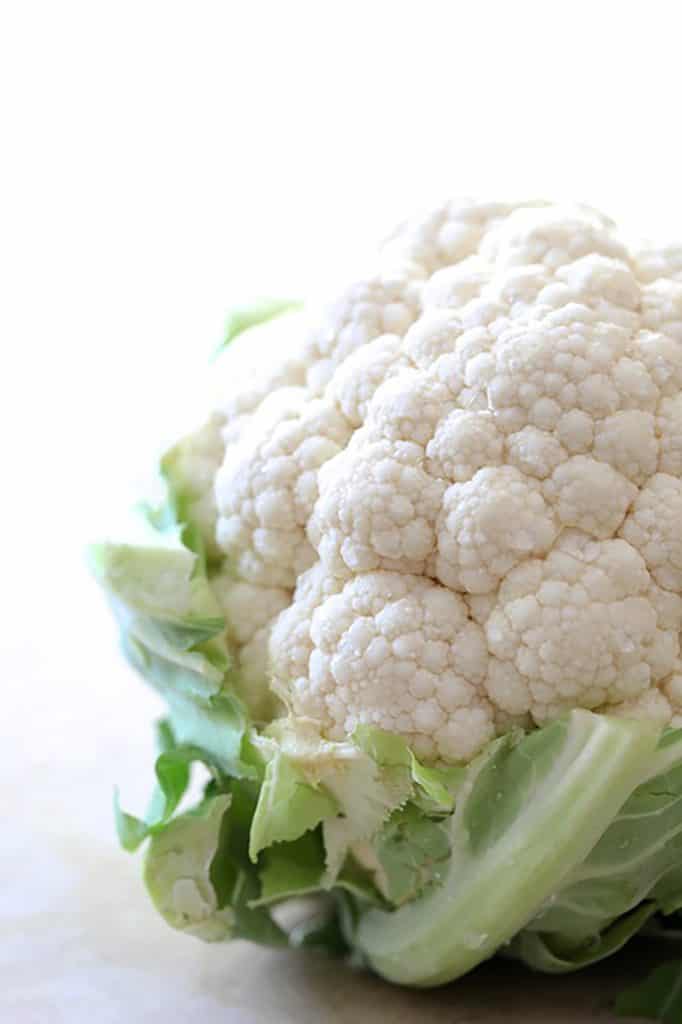 Close-up photo of a large head of white cauliflower.