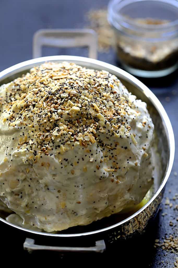 Process photo of cauliflower in roasting pan before roasting.