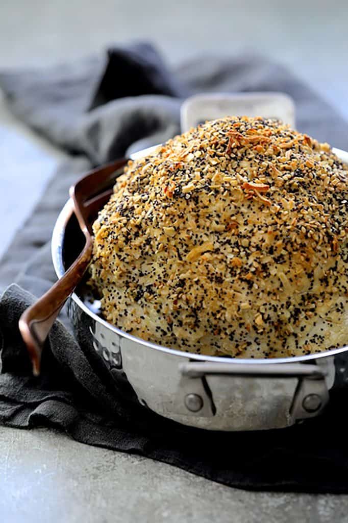 Photo of Everything Bagel Spice Whole Roasted Cauliflower in roasting pan after roasting.