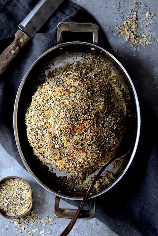 Everything Bagel Spice Whole Roasted Cauliflower in oval stainless steel roasting pan.