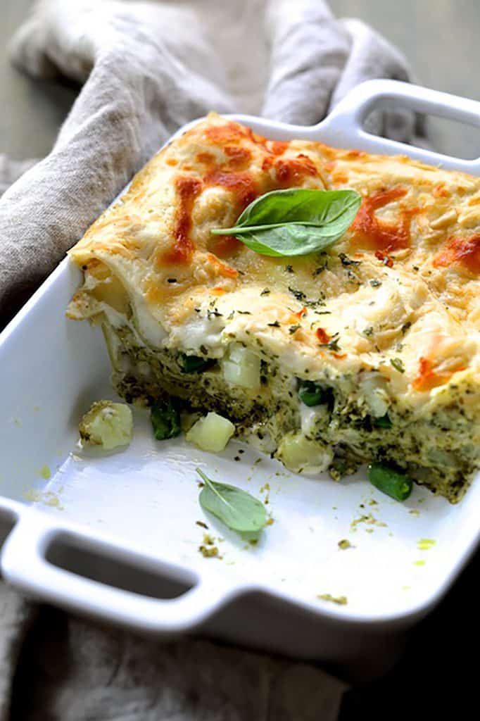 Photo of Lasagna with Pesto Green Beans and Potatoes cut into showing the layers of pasta, potatoes and green beans.
