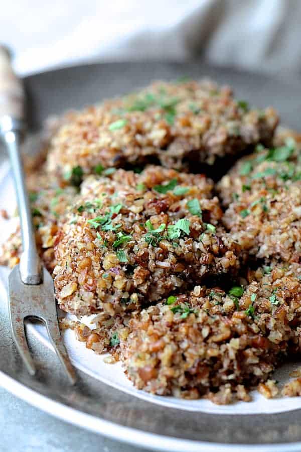 Photo of Pecan Crusted Turkey Cutlets on gray-rimmed platter with serving fork.