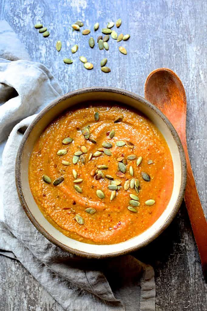 Photo of cooked pumpkin grits in clay bowl.