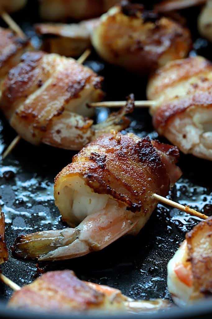Close-up photo of cooked bacon-wrapped shrimp.