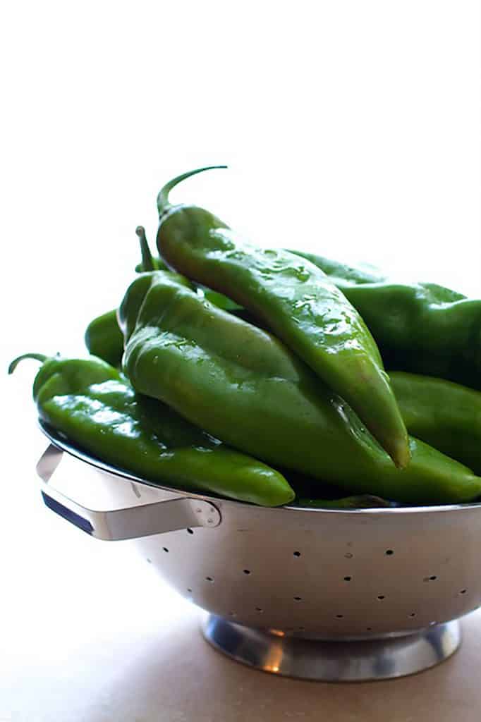 Photo of stainless steel colander full of Hatch green chiles.