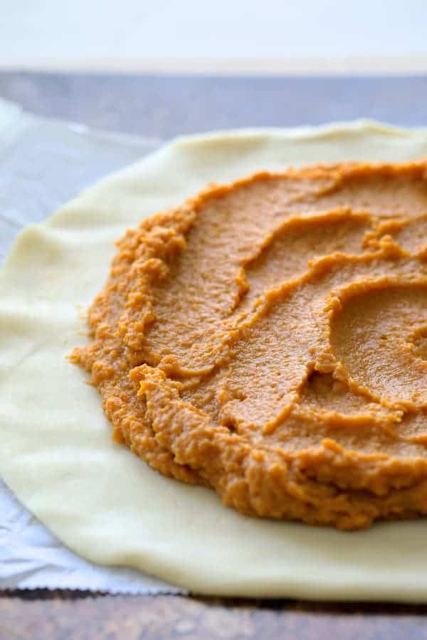 Process of sweet potato combination on dough before folding edges over and before baking.