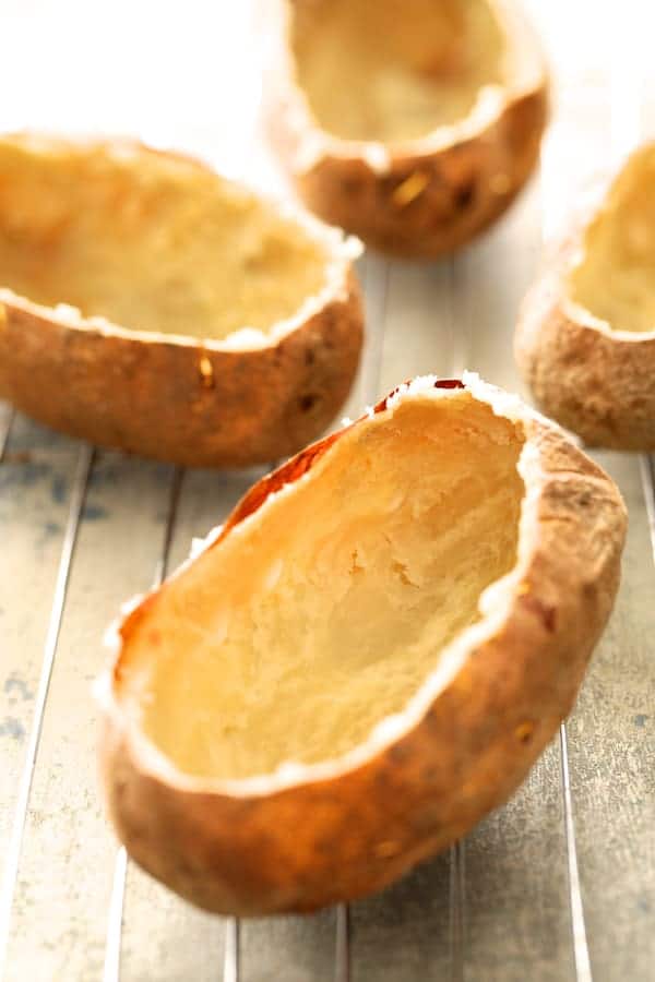 Photo of hollowed out potatoes on cooling rack.