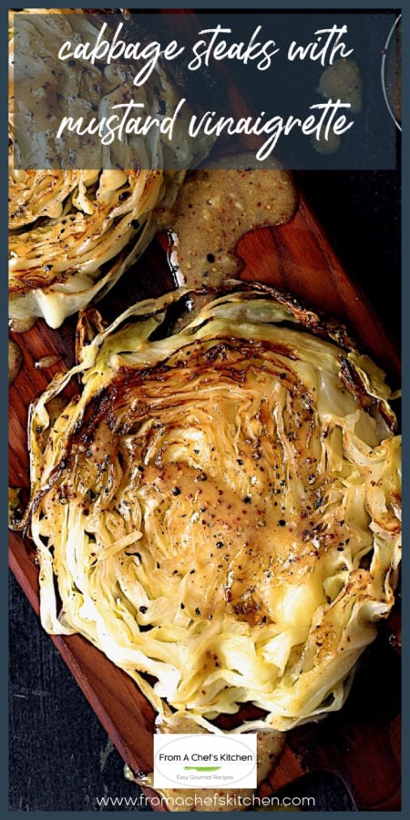 Cabbage steaks on wood cutting board with vinaigrette drizzled over them.
