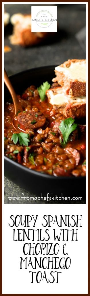 Pinterest graphic for Soupy Spanish Lentils with Chorizo and Manchego Toast showing it in a black bowl with copper fork and garnished with fresh parsley.