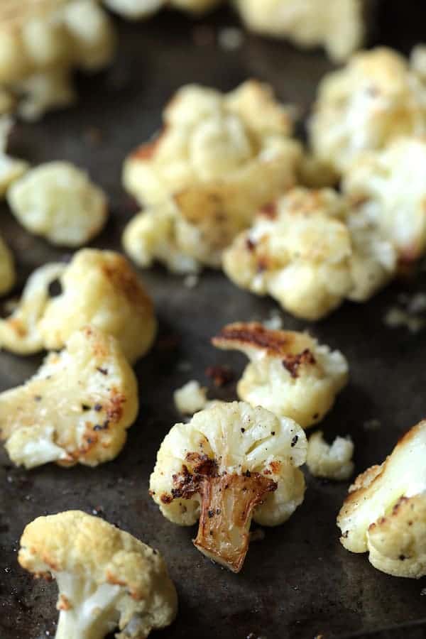 Photo of roasted cauliflower on baking sheet after being roasted.