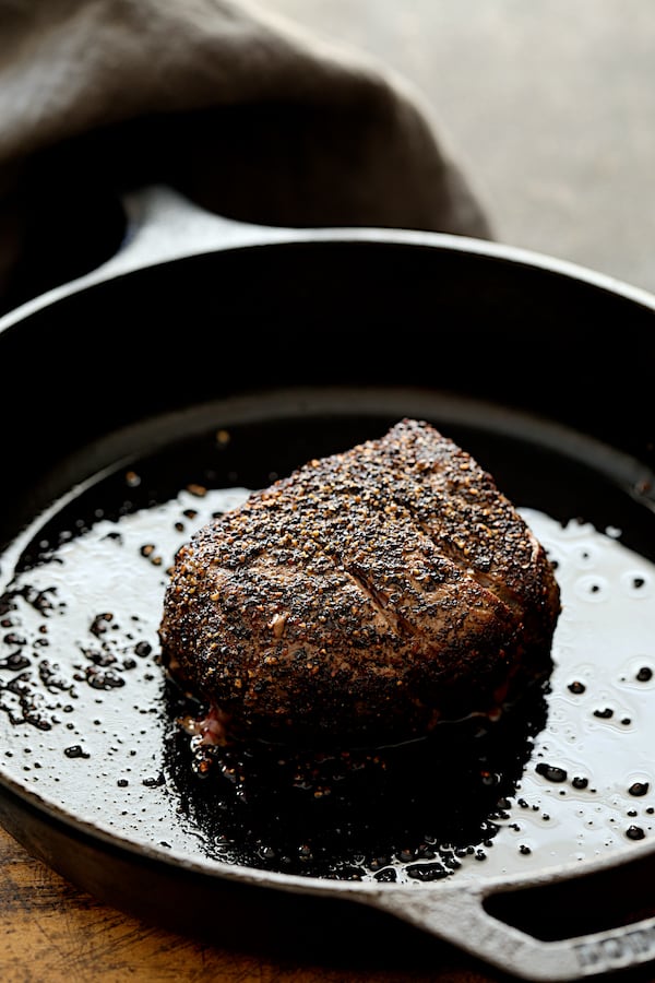 Photo of browned steak in cast iron skillet.