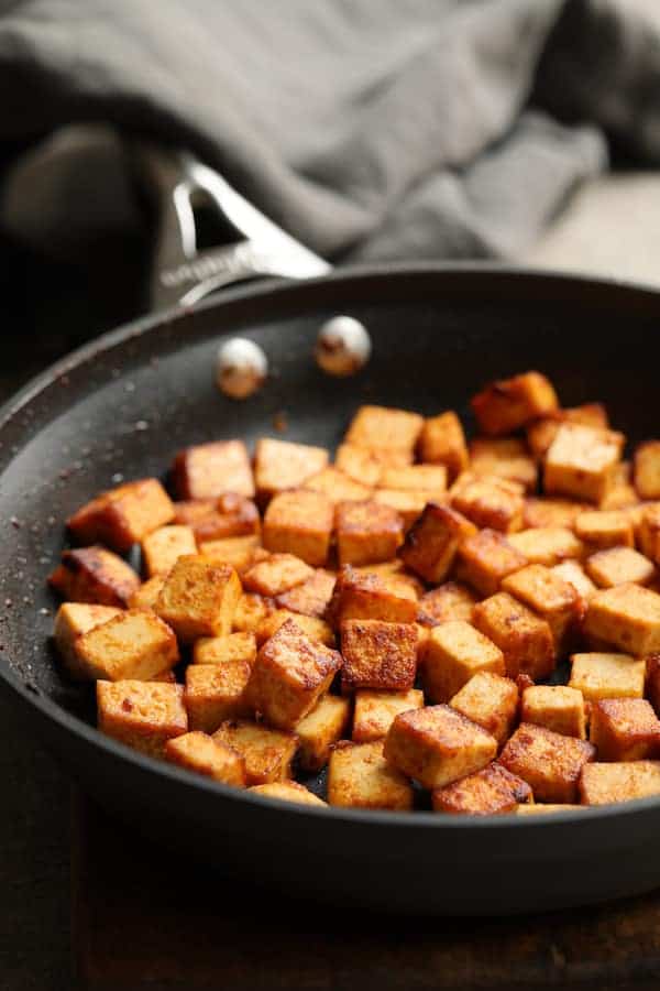 Photo of browned tofu in frying pan.