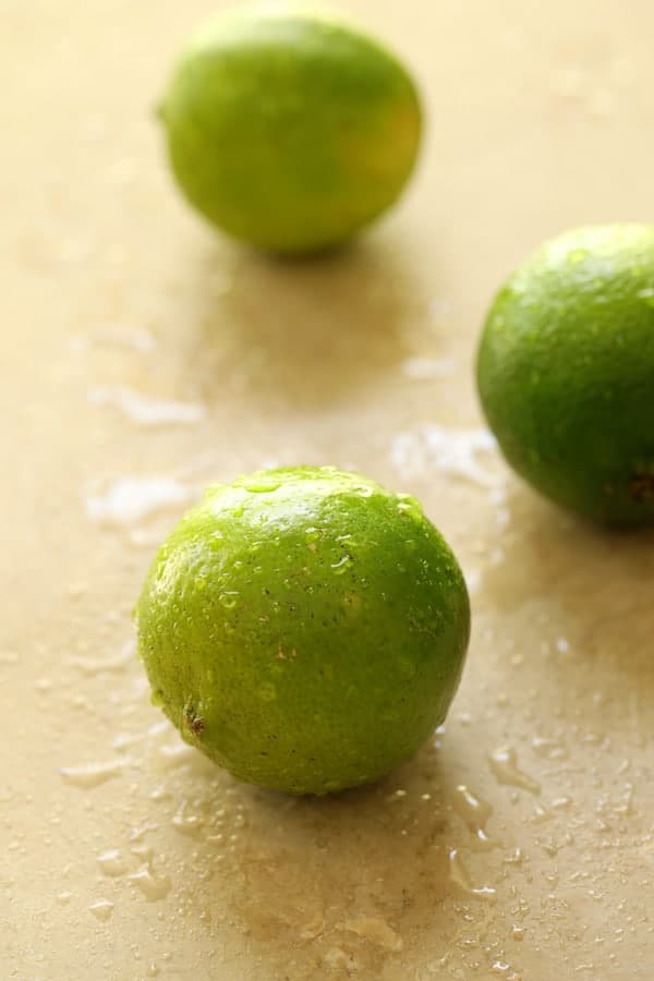 Photo of three freshly washed limes.