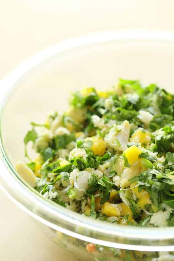 Photo of Crab Mango and Avocado Salad with Chile Lime Dressing in glass bowl.