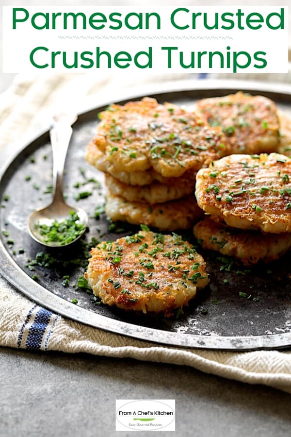 Pinterest graphic for Parmesan Crusted Crushed Turnips showing them garnished with chopped fresh chives on metal platter.