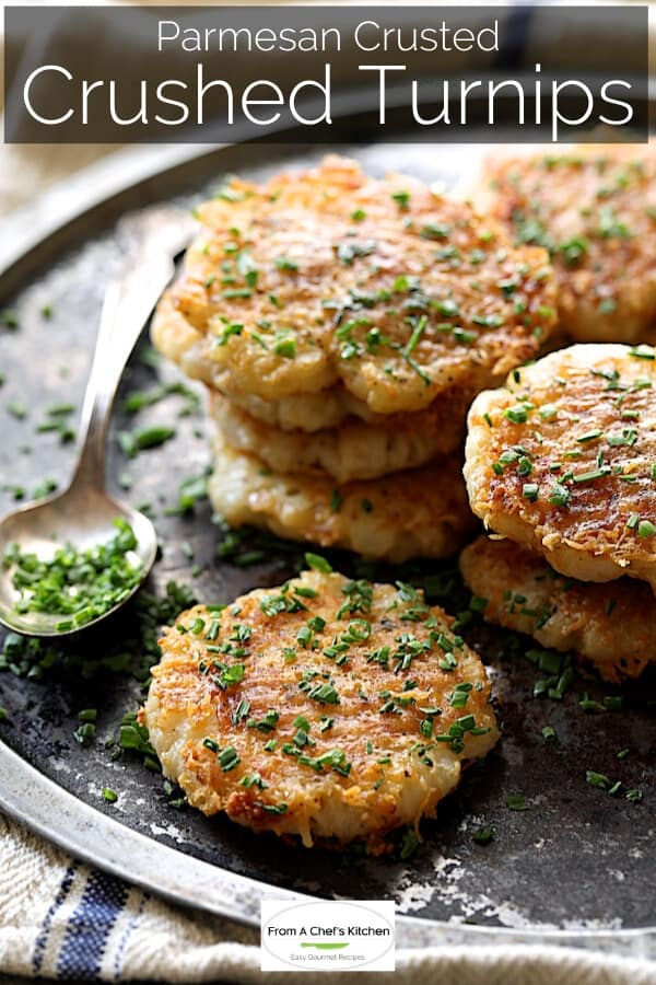 Pinterest graphic for Parmesan Crusted Crushed Turnips showing them garnished with chopped fresh chives on metal platter.