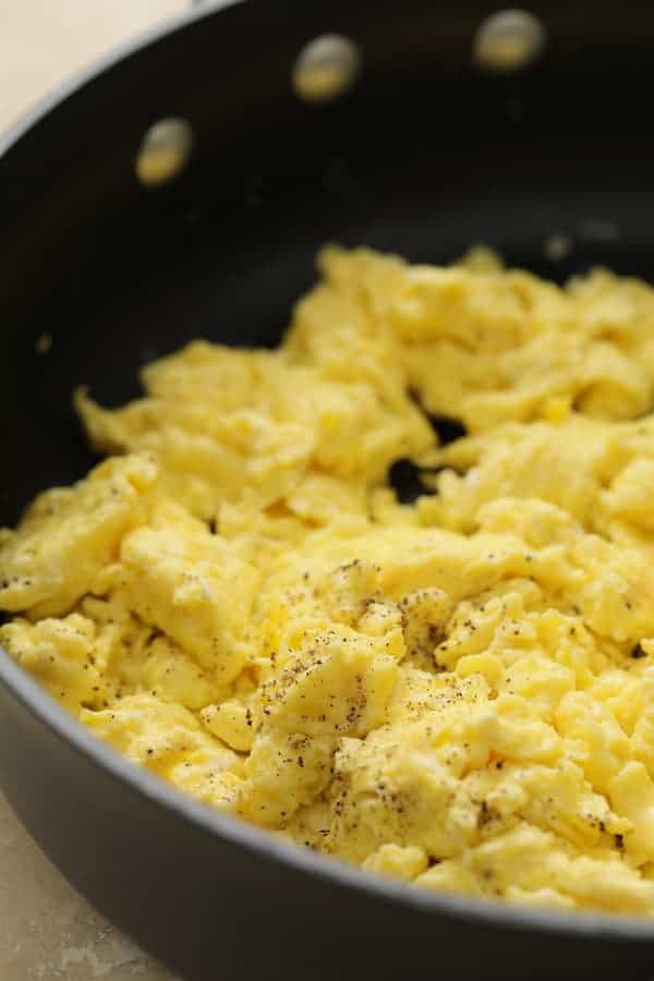 Photo of cooked scrambled eggs in nonstick skillet.