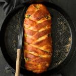 Savory Breakfast Strudel with Eggs Sausage and Swiss Chard - Hero shot in cast iron pan after baking