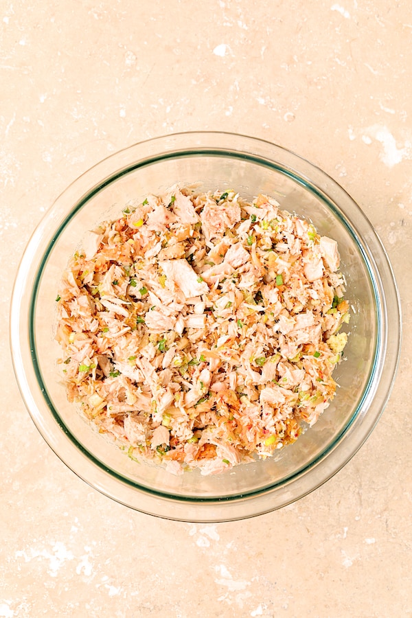 Photo of tuna kimchi mixture in glass mixing bowl.