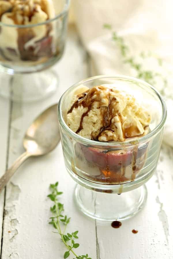 Photo of Grilled Peaches with Vanilla Ice Cream and Honey Balsamic Drizzle in glass serving dish.
