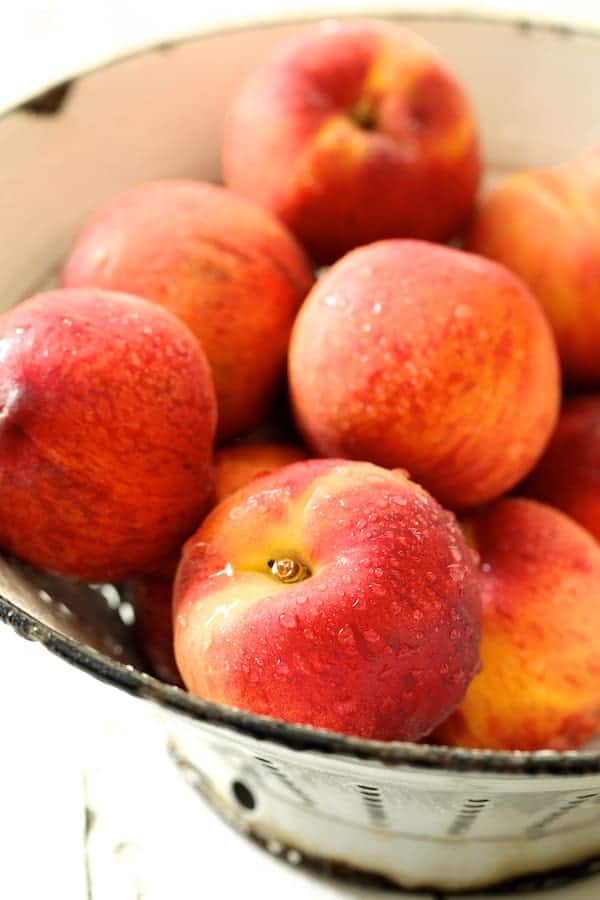 Close-up photo of freshly washed peaches.