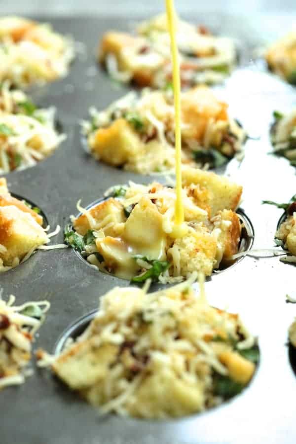Photo of unbaked stratas with custard being poured over them.