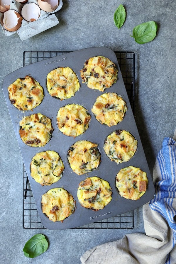 Photo of Muffin Pan Stratas with Basil and Sun-Dried Tomatoes in muffin pan after being baked.